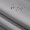 A close-up view of a light gray fabric with water droplets on its surface, suggesting a waterproof feature. Produktbild-Vorschau