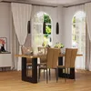 A dining room with a table and chairs set up for a meal. Produktbild-Vorschau