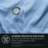 A split image showing a stained fabric before and after washing, with text describing the washing program's effectiveness. Voir les images du produit