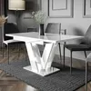 A modern dining room setting with a white high-gloss extendable dining table and dark gray chairs. Produktbild-Vorschau
