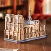A wooden model of the Notre Dame Cathedral sits on a wooden table. Náhled obrázku produktu