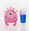 A pink monster toy and a tube of toothpaste are displayed against a white background. Anteprima dell’immagine prodotto