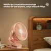A pink clip-on fan is displayed on a bedside table next to a wooden headboard. Produktbild-Vorschau