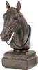 A dark brown horse head sculpture on a square base, with a black beaded necklace around its neck. Produktbild-Vorschau