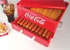 A Coca-Cola branded hot dog steamer filled with hot dogs and buns, with a glass of Coca-Cola and a prepared hot dog in the foreground. Anteprima dell’immagine prodotto