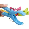 A hand holding a blue clothespin with other colored clothespins in the background. Produktbild-Vorschau