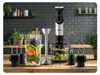 A kitchen counter with a hand blender and its accessories, along with ingredients for a smoothie. Náhľad obrázku produktu