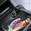 A car's center console with a phone and charging accessories. Produktbild-Vorschau
