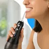A woman is using a cordless water flosser to clean her teeth. Voir les images du produit