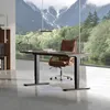 An office desk with a chair in front of a large window with a mountain view. Produktbild-Vorschau