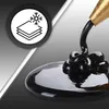 Black liquid being dispensed from a nozzle onto a surface, with a circular graphic showing layers and a snowflake. Voir les images du produit