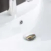 A close-up view of a white ceramic sink with chrome fixtures. Produktbild-Vorschau
