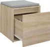 A close-up view of a wooden storage box with a gray cushion on top. The drawer is partially open, revealing some items inside. Náhľad obrázku produktu