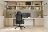 A gaming chair and desk setup in a modern office with bookshelves. Produktbild-Vorschau