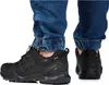 Close-up view of a person wearing black Adidas Terrex hiking shoes and blue jeans. Anteprima dell’immagine prodotto