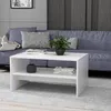 A white coffee table is placed in front of a blue sofa in a living room setting. Anteprima dell’immagine prodotto