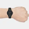 A close-up shot of a black Armani Exchange watch on a person's wrist. Anteprima dell’immagine prodotto