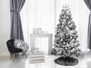 A decorated artificial Christmas tree with silver ornaments and ribbons, set up in a room with a chair, a fireplace, and gifts. Podgląd zdjęcia produktu