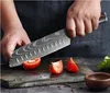 A person is cutting tomatoes with a knife on a wooden cutting board. Voir les images du produit
