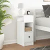 A white nightstand with a drawer and shelves is placed next to a bed. Anteprima dell’immagine prodotto