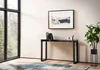 A modern living room with a console table, artwork, and a plant. Produktbild-Vorschau