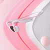 A pair of pink and white Shokz bone conduction headphones are displayed against a soft pink and white abstract background. Produktbild-Vorschau