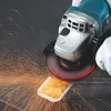 An angle grinder is being used to grind a metal object, creating a shower of sparks. Podgląd zdjęcia produktu