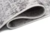 A close-up view of a rolled-up rug, showing the texture and edge binding. Náhled obrázku produktu