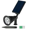 A black solar-powered spotlight with a solar panel, shown on a white background with some accessories. Voir les images du produit