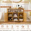 A bamboo bathroom storage cabinet with various items on its shelves, set in a bathroom environment. Podgląd zdjęcia produktu