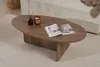 A walnut coffee table with a book and candle on it, placed on a rug in a living room setting. Anteprima dell’immagine prodotto