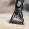 A close-up of a Kärcher cleaning attachment being used on a textured fabric surface. Anteprima dell’immagine prodotto
