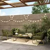 An outdoor patio setting with a lounge set and coffee table under a wooden pergola, decorated with string lights. Produktbild-Vorschau