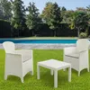 A white garden furniture set consisting of a table and two chairs is placed on a green lawn in front of a swimming pool. Produktbild-Vorschau