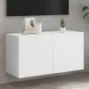 A white wall-mounted TV cabinet with two doors, shown in a living room setting. Produktbild-Vorschau