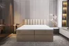 A bedroom scene featuring a beige upholstered box spring bed with a white mattress and a beige headboard. Produktbild-Vorschau