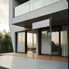 A modern house with a wooden deck and a retractable awning. Produktbild-Vorschau