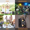 Collage of four scenes showing a portable Bluetooth speaker being used in different settings: yoga, square dancing, a picnic party, and outdoor travel. Podgląd zdjęcia produktu