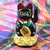 A black Maneki-neko (lucky cat) figurine sits on a base of gold coins against a colorful, abstract background. Produktbild-Vorschau