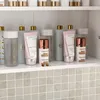 A shelf displaying various cosmetic products, including bottles and tubes, with a tiled backsplash. Náhľad obrázku produktu