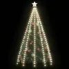 A decorated Christmas tree with lights and ornaments against a black background. Podgląd zdjęcia produktu