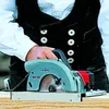 A person is using a circular saw to cut wood. Produktbild-Vorschau