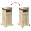 Two identical wooden podiums with wheels, drawers, and cabinets are shown against a white background. A purple arrow graphic indicates movement or comparison between the two podiums. Náhled obrázku produktu