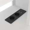 A close-up view of a black power strip with two outlets and two USB ports, integrated into a white surface. Produktbild-Vorschau