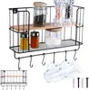 A black metal kitchen shelf with a wooden shelf is displayed, holding various jars and spice containers. Two glass mugs hang from hooks below the shelf. Anteprima dell’immagine prodotto
