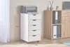 A white roll container with five drawers is shown next to a wooden cabinet. A printer sits on top of the roll container. Dimensions are indicated with lines and text. Produktbild-Vorschau