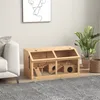 A wooden hamster cage is placed on a rug in a living room setting, next to a sofa and a potted plant. Voir les images du produit