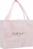 A pink marble patterned gift box with pink ribbon handles and gold text that says "The Best Wishes to you". Náhled obrázku produktu