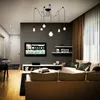 A modern living room with a TV, sofa, and a spider-like chandelier. Produktbild-Vorschau