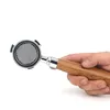 A hand holding a portafilter for an espresso machine against a white background. Náhled obrázku produktu